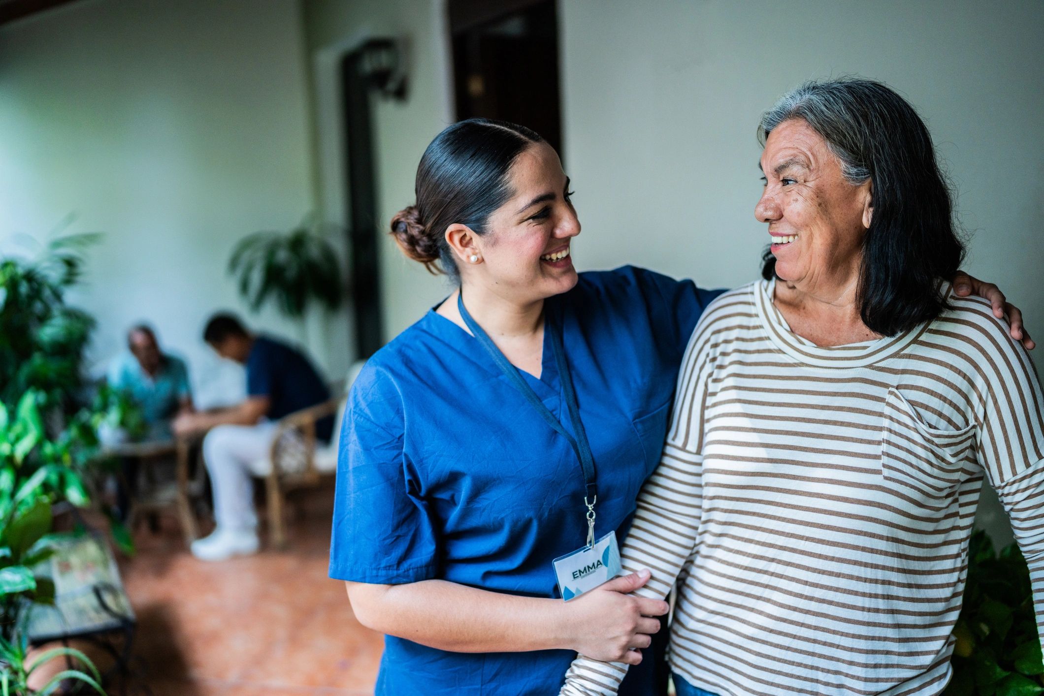 Caregiver speaking with a senior woman at home