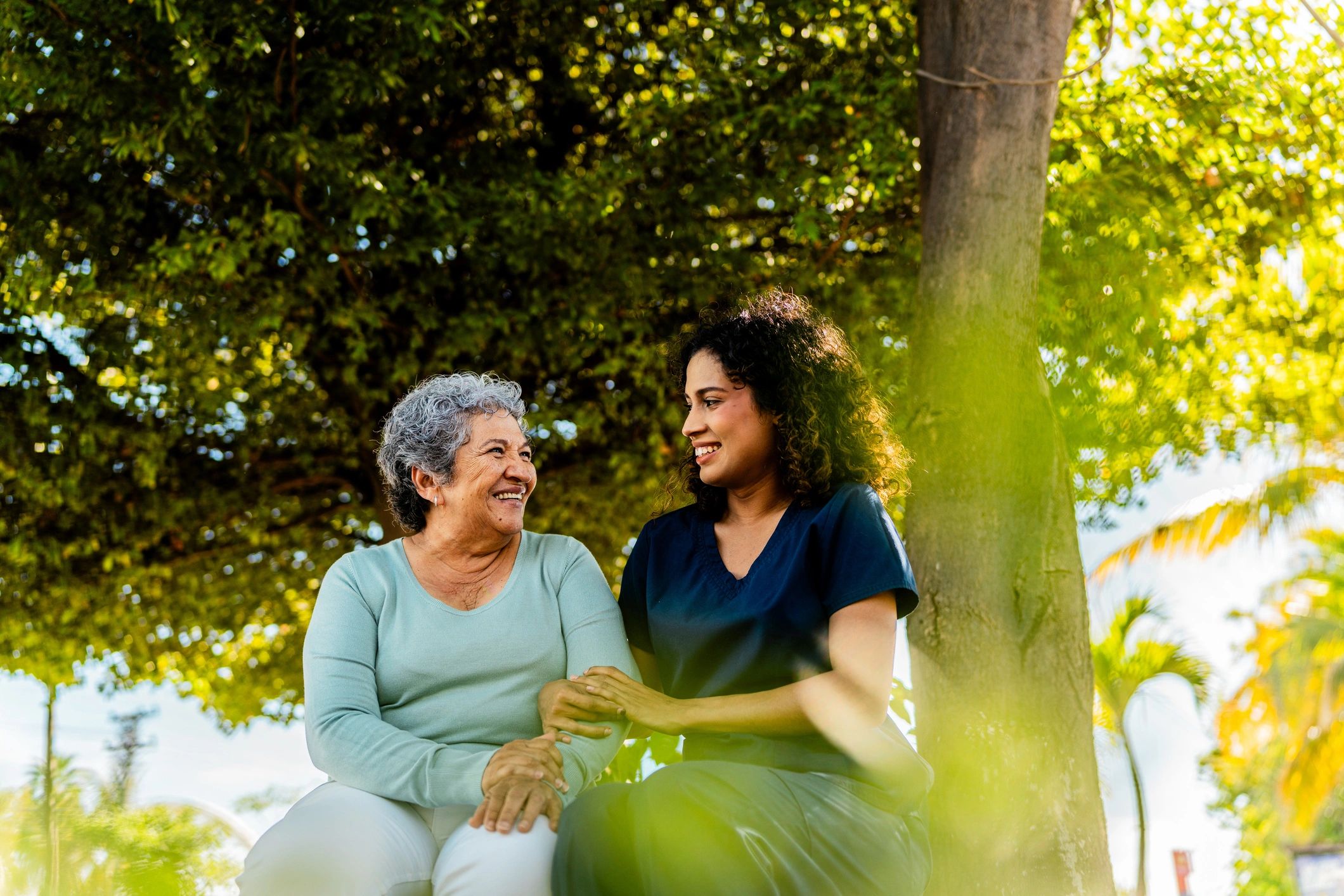 Caregiver talking with an older adult outdoors