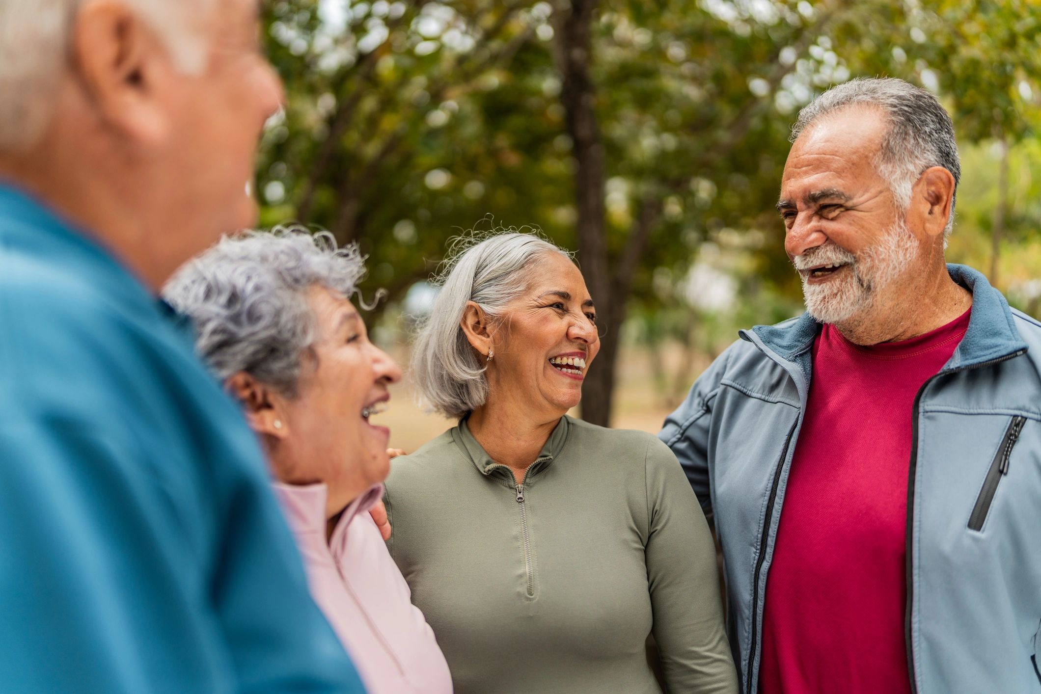 Senior friends enjoying conversation in a park